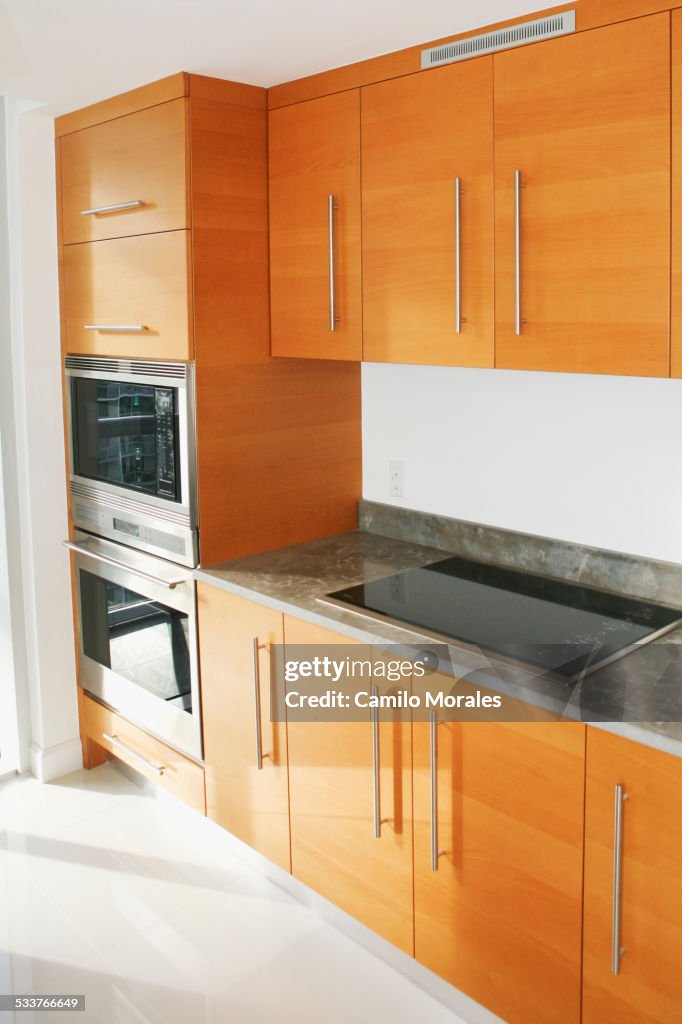 Cabinets, counters and stove in modern kitchen