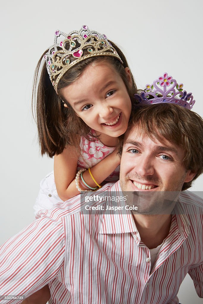 Father and daughter wearing tiaras