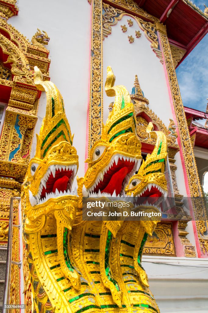 Golden statues outside ornate temple, Doi Saket District, Chiang Mai, Thailand