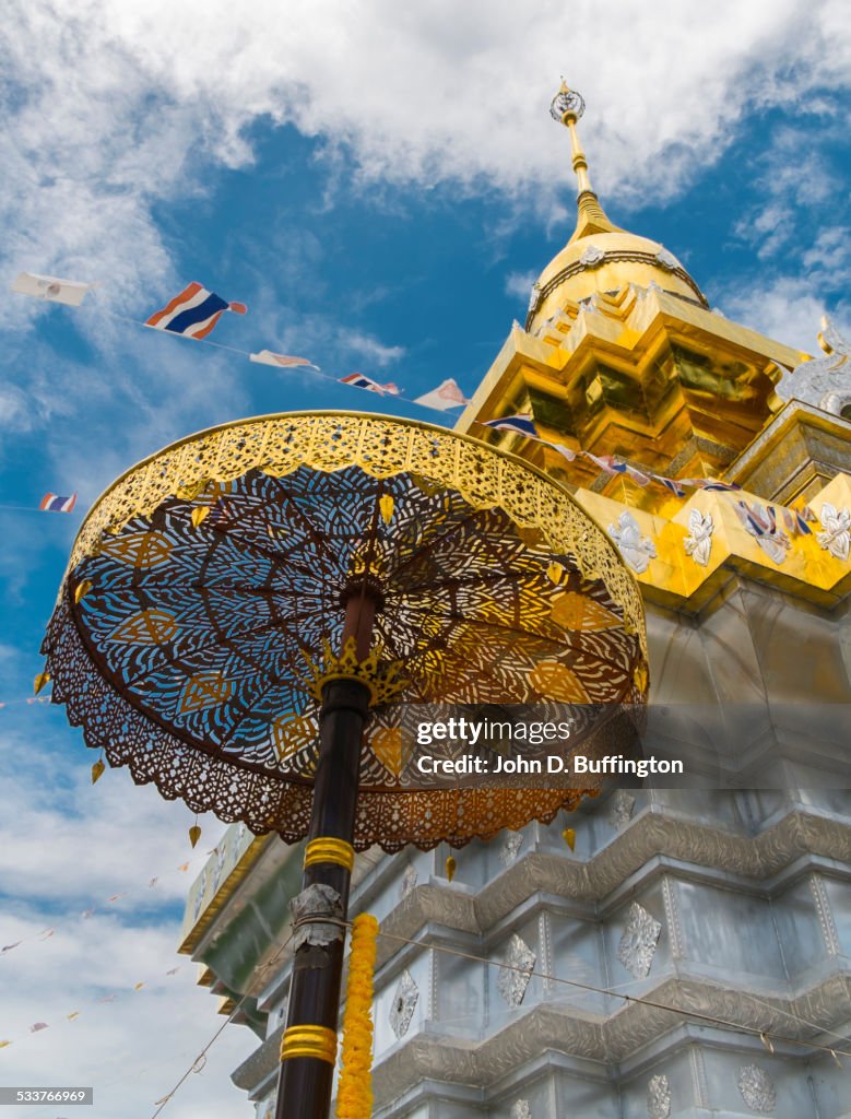Golden umbrella outside ornate temple, Doi Saket District, Chiang Mai, Thailand