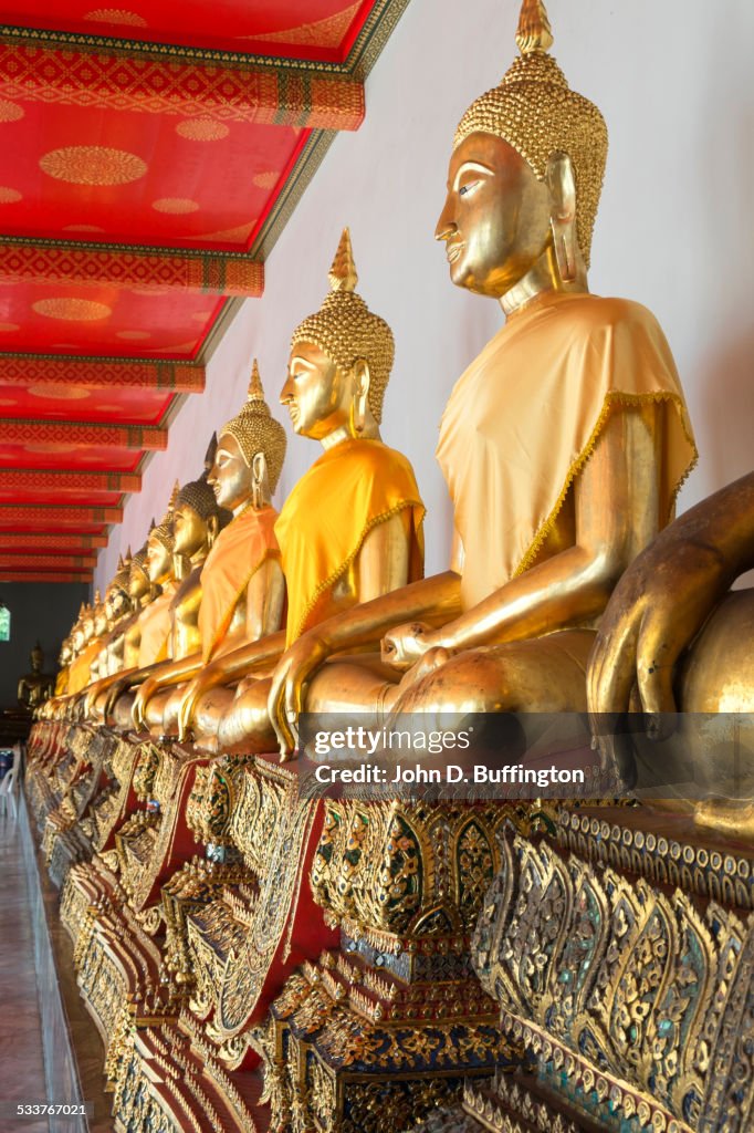 Close up of golden Buddha statues in ornate temple, Bangkok, Thailand