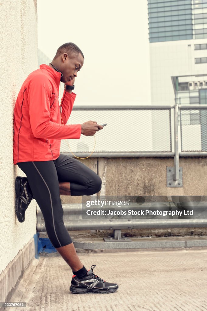 African American runner using cell phone