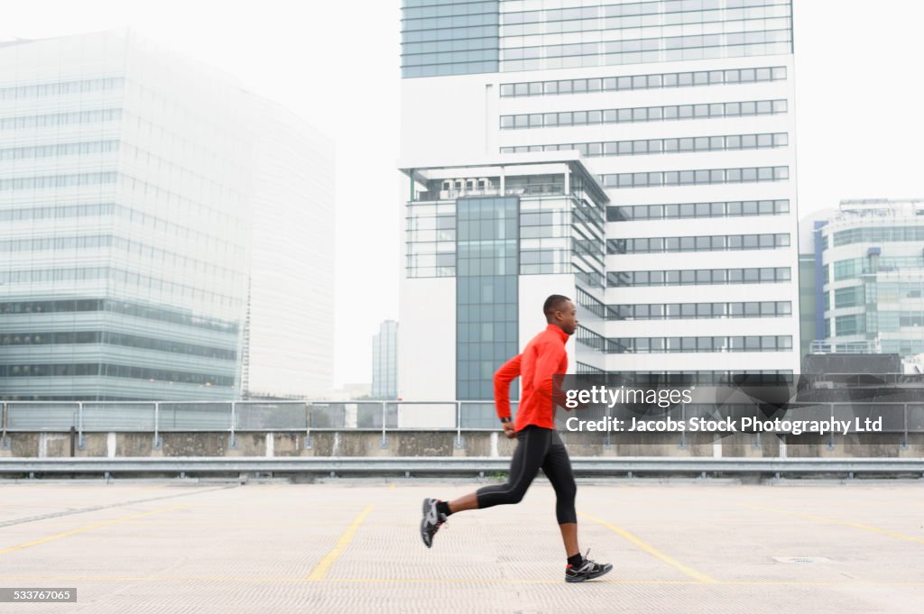 African American runner jogging in city