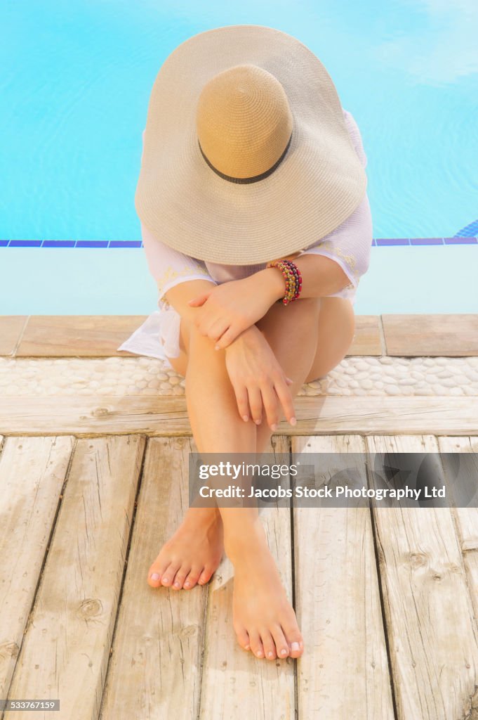 Caucasian woman relaxing near swimming pool