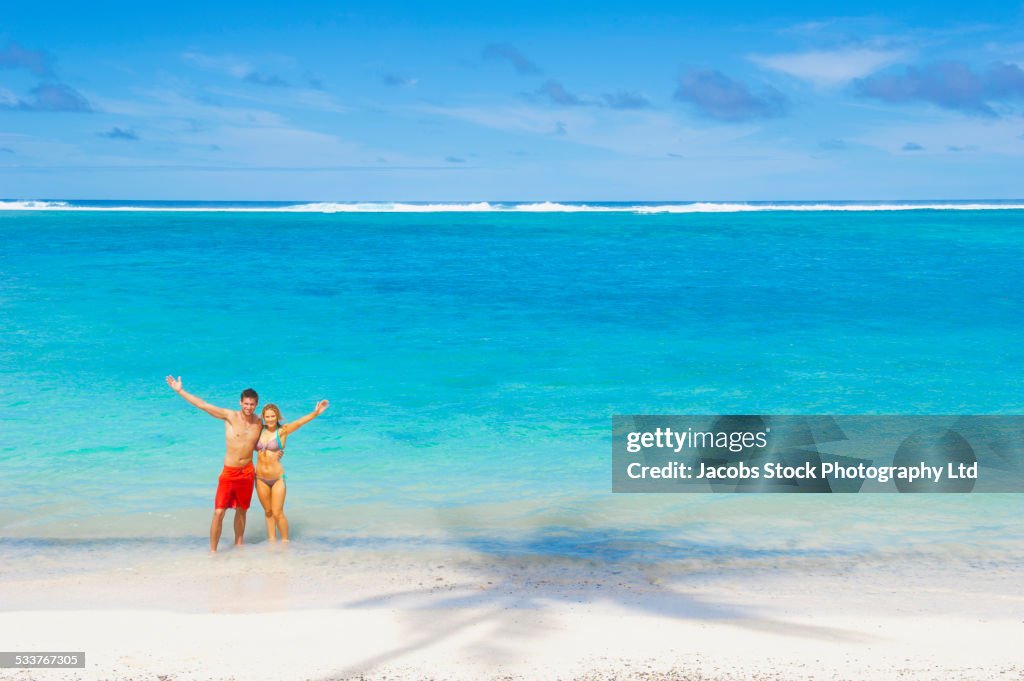 Caucasian couple posing on beach