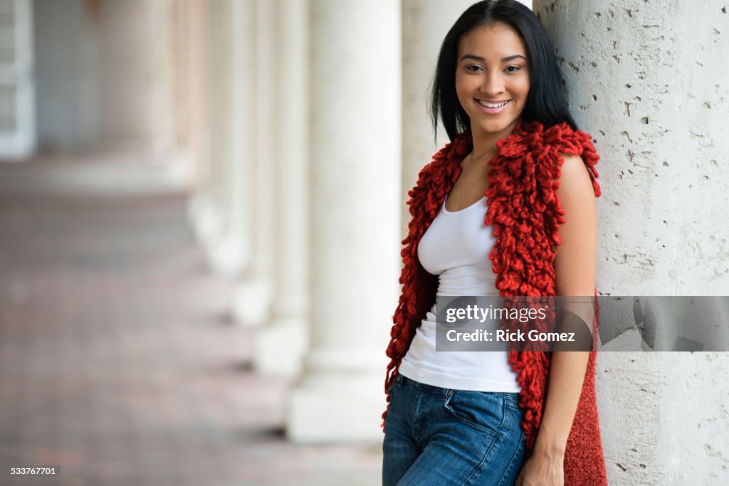 Black woman leaning on pillar