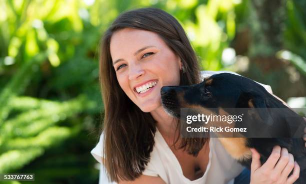 caucasian woman playing with dog outdoors - delray beach bildbanksfoton och bilder