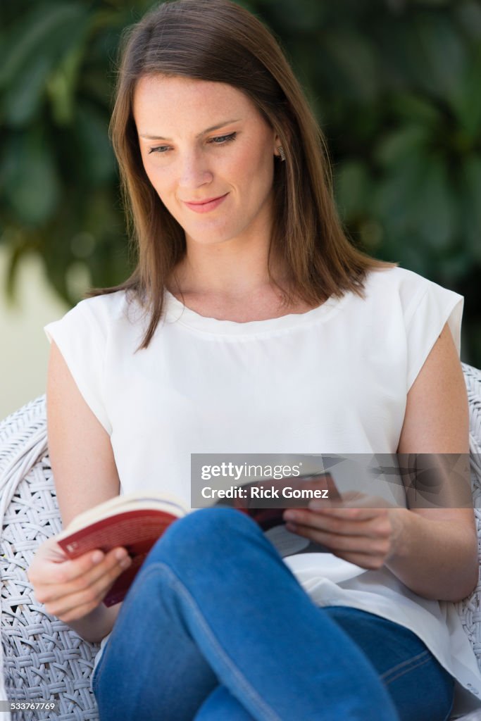 Caucasian woman reading outdoors