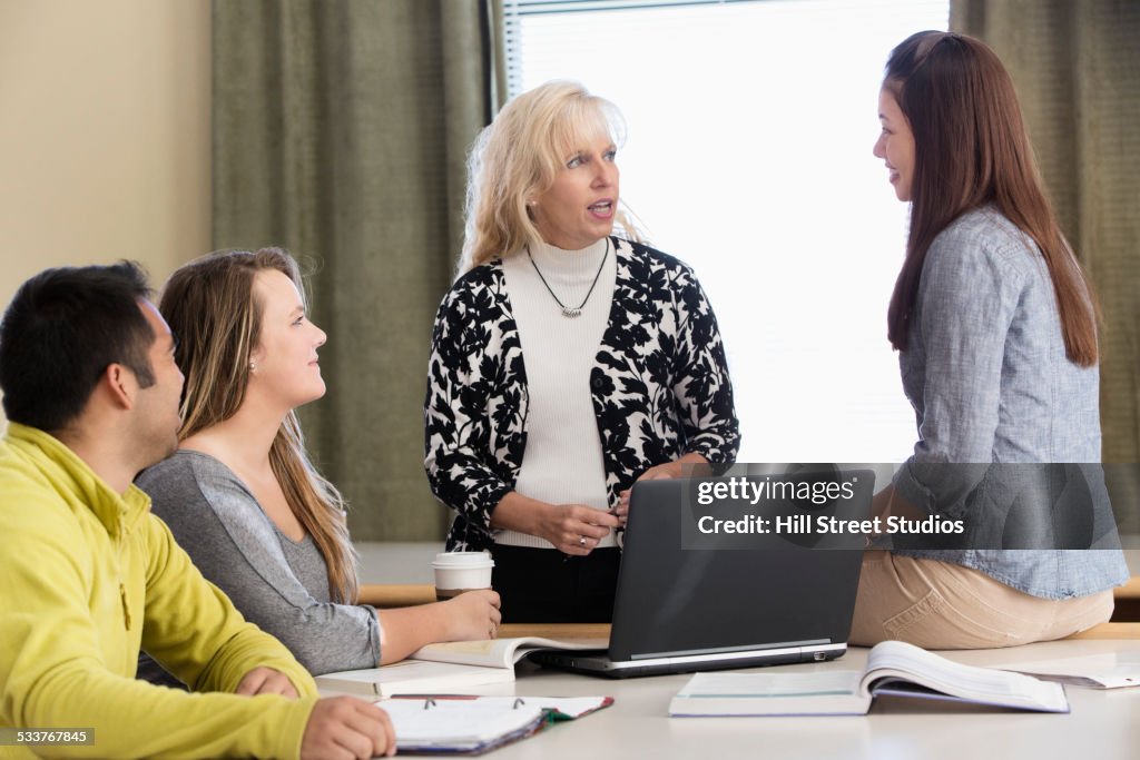 Teacher and students talking in meeting