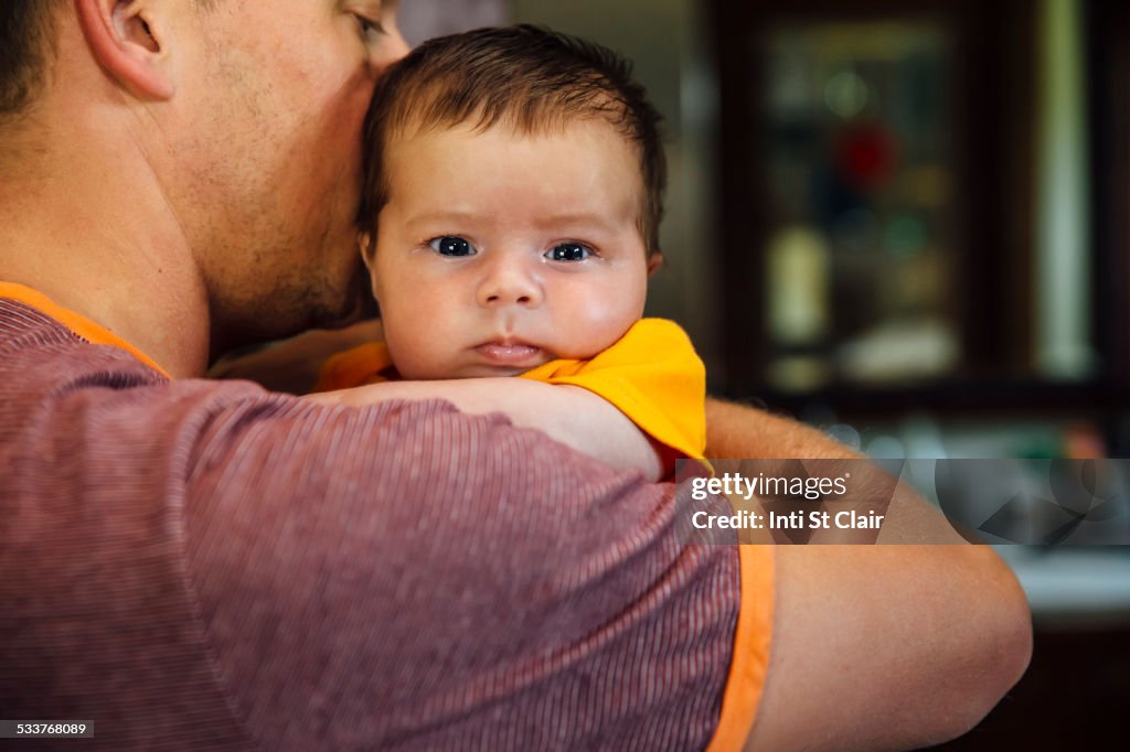 Caucasian father holding baby boy