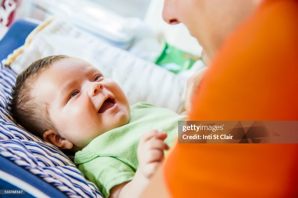 Caucasian father playing with baby boy