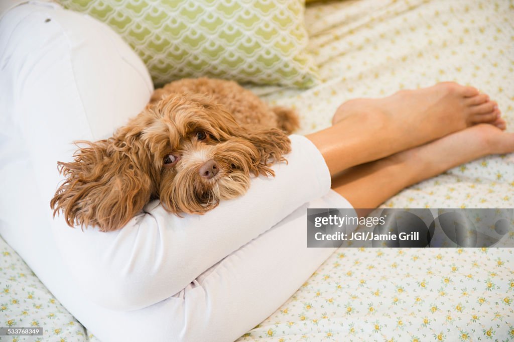 Caucasian woman relaxing with pet dog
