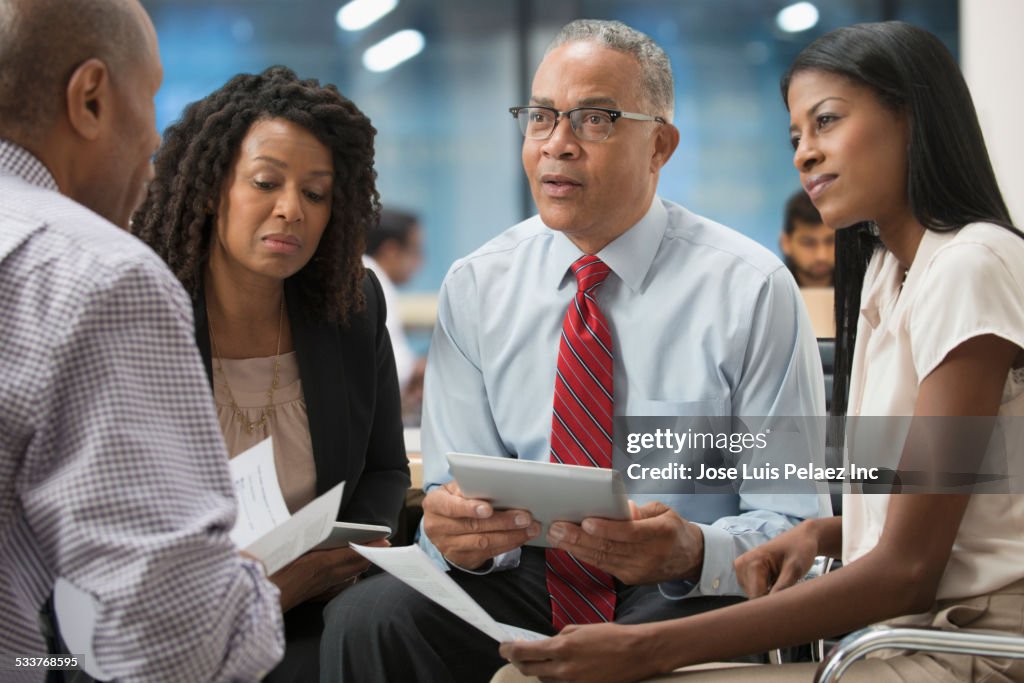 Business people using digital tablet in office meeting