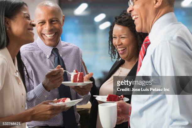 business people celebrating birthday in office - lob wedge stock-fotos und bilder