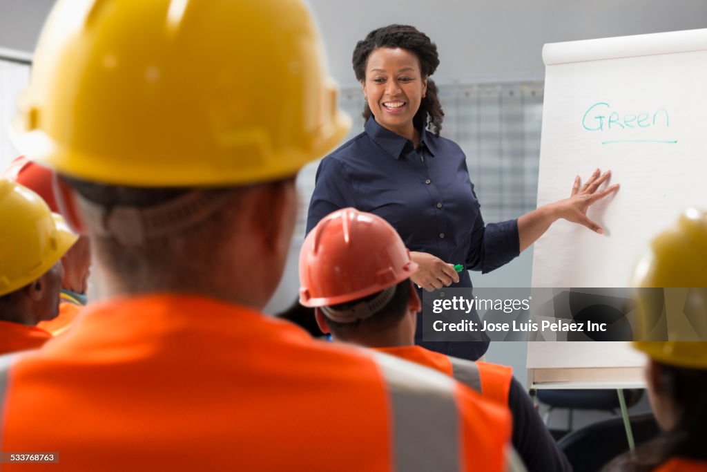 Speaker giving presentation to construction workers