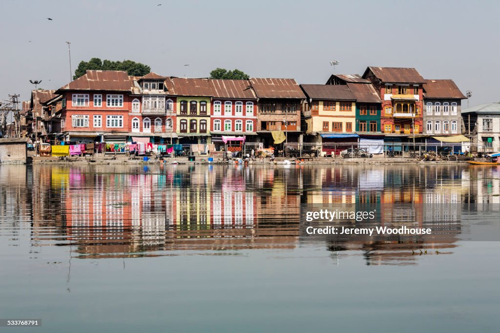 Buildings reflected in still river