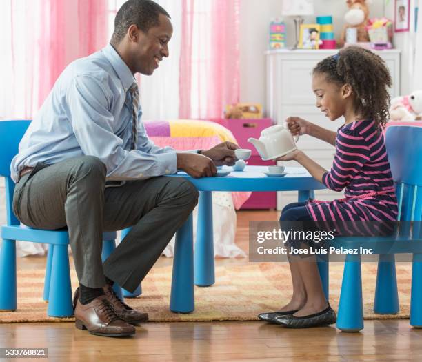 father and daughter having tea party in playroom - tea party 個照片及圖片檔