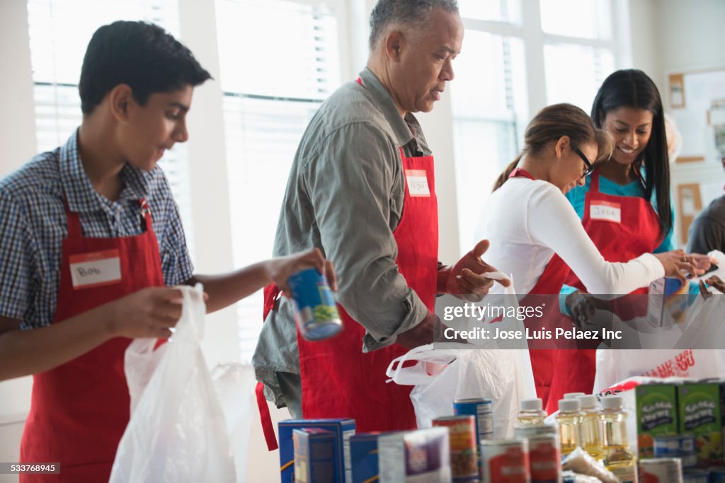 Volunteers packing canned goods at food drive