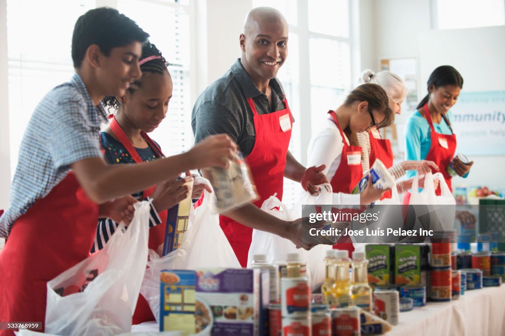 Volunteers packing canned goods at food drive