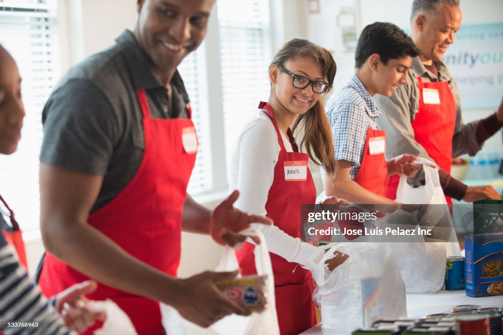 Volunteers packing canned goods at food drive