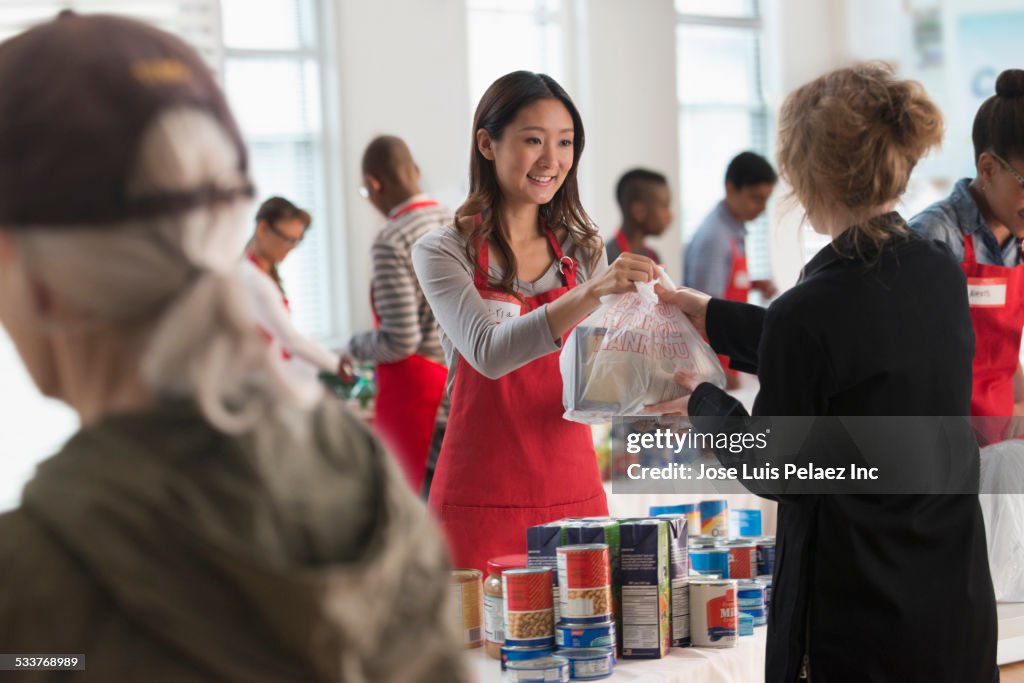 Volunteers handing out food at food drive