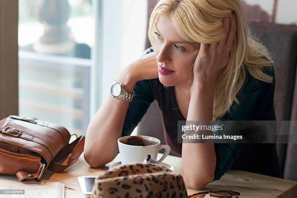 Woman sitting alone in cafe