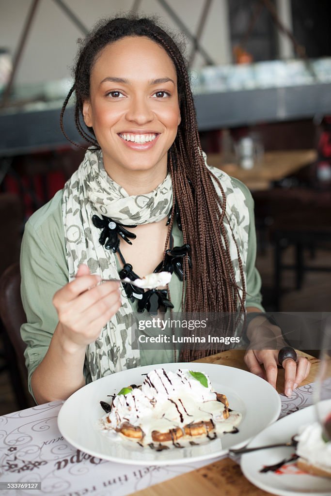 Woman eating dessert in cafe