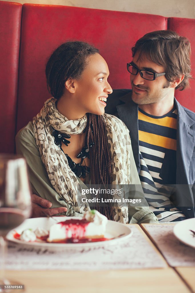 Couple eating dessert in cafe