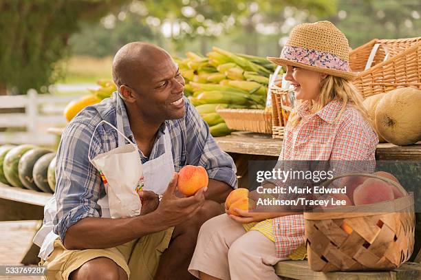 vendor talking to girl at farmers market - tracey crouch stock pictures, royalty-free photos & images