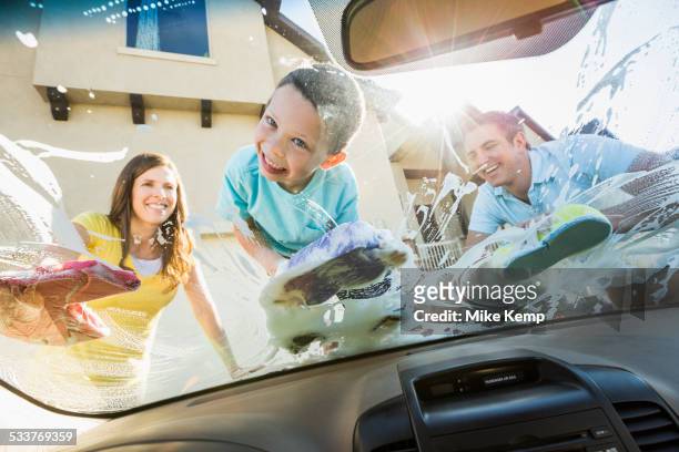 caucasian father and children washing car windshield - clean car stock pictures, royalty-free photos & images