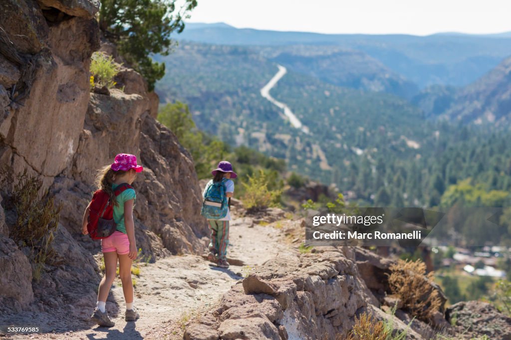 Children hiking together on rocky mountainside