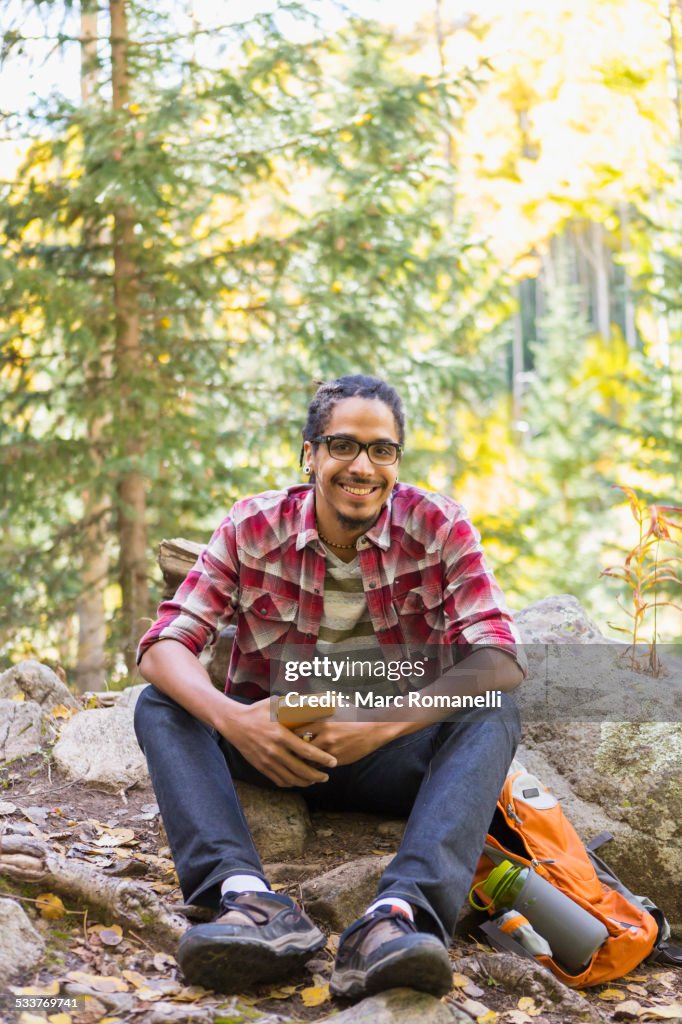 Mixed race hiker smiling in forest