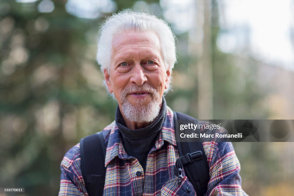 Caucasian hiker smiling in forest