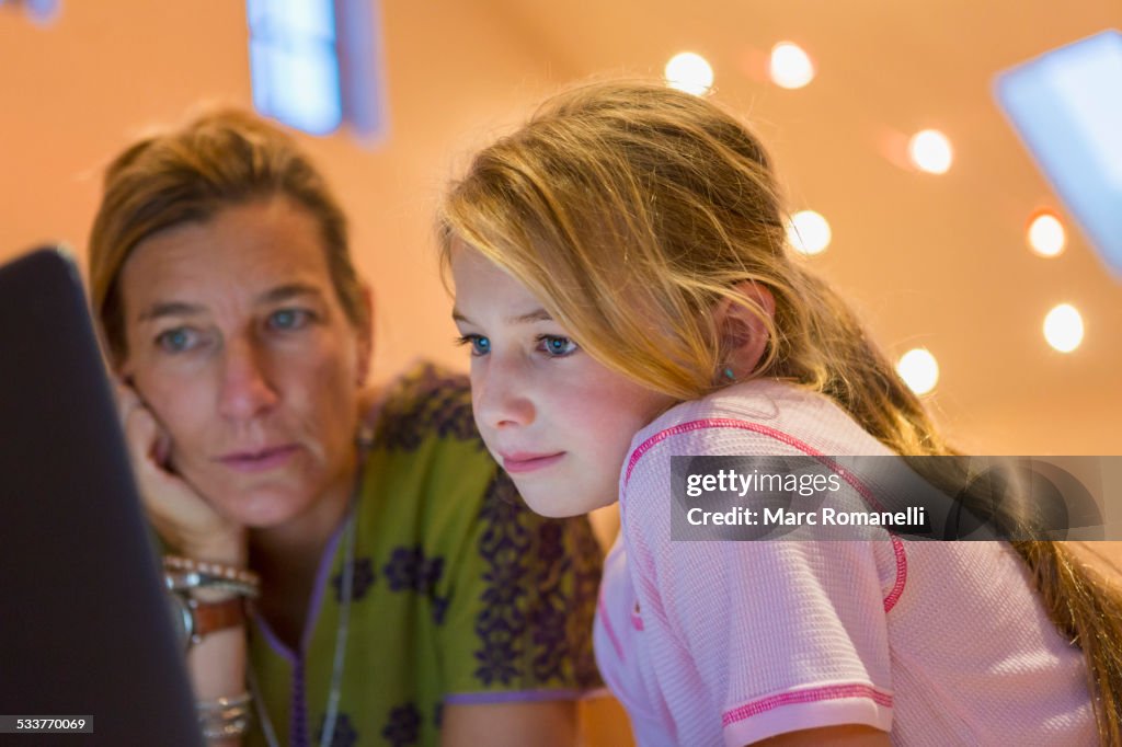 Caucasian mother and daughter using computer together