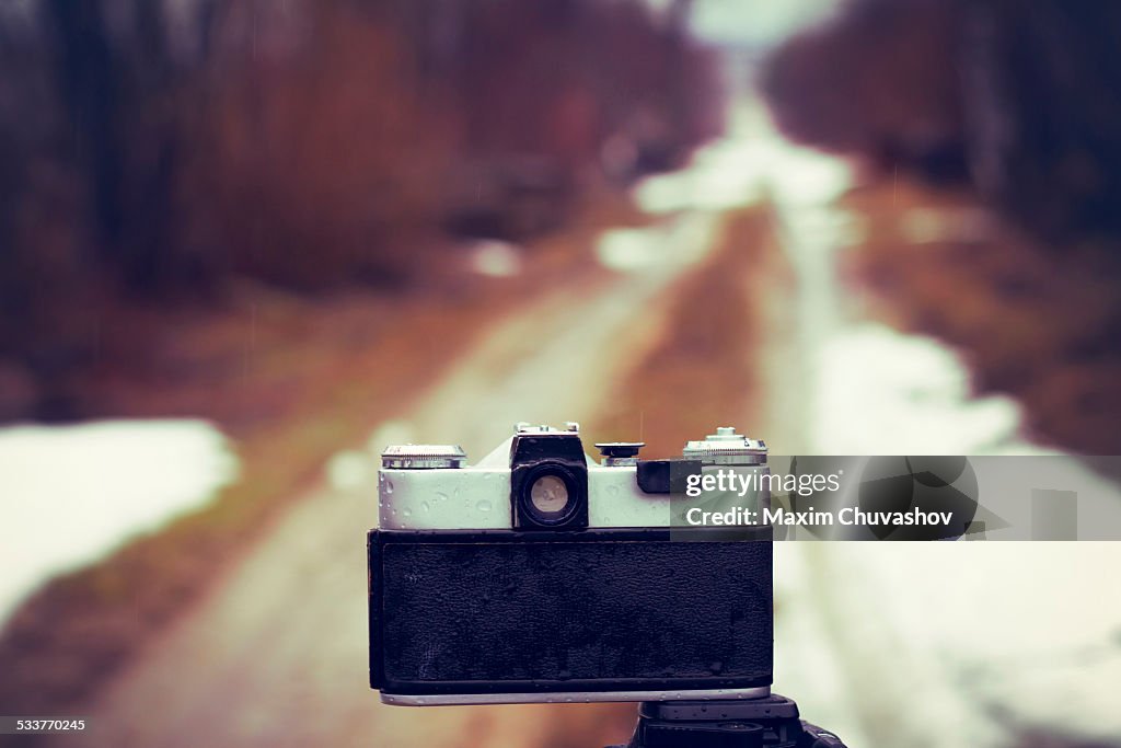 Close up of camera on tripod on snowy road