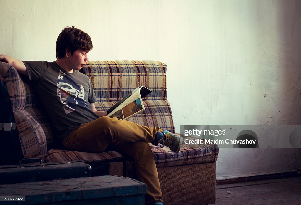 Caucasian man reading in living room