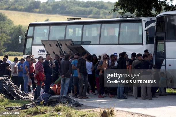 People board in a bus in order to leave the refugee and migrant makeshift camp on the Greek-Macedonia border near the village of Idomeni on May, 23...