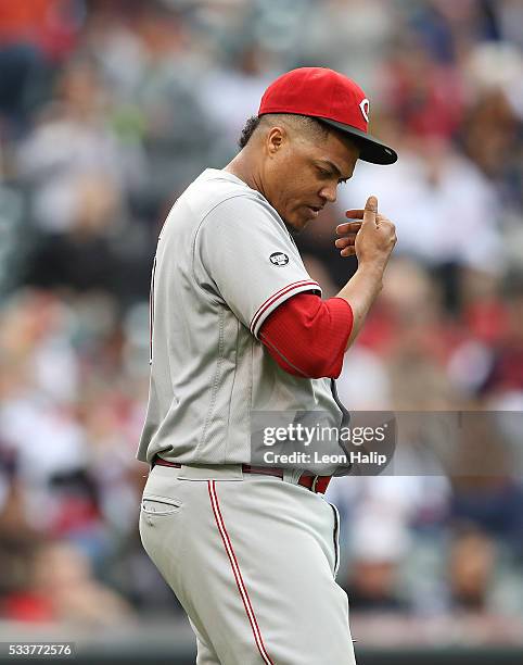 Alfredo Simon of the Cincinnati Reds reacts after giving up a hit during the fourth inning of the interleague game against the Cleveland Indians on...