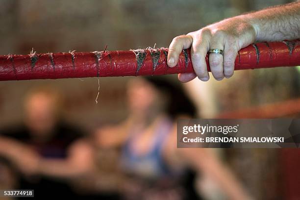 Alex Buettiker, a referee whose ring name is Waylon Alexander, rests on the ropes during drills at Boogie's Pro Wrestling Camp May 22, 2016 in...