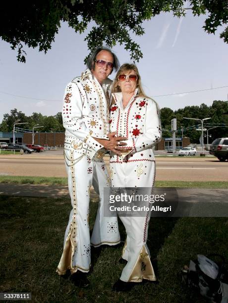 Elvis fans Tom Elliott and wife Robin Elliott from Illinois pose for a photo at Graceland Crossing during Elvis Week 2005 August 12, 2005 in Memphis,...