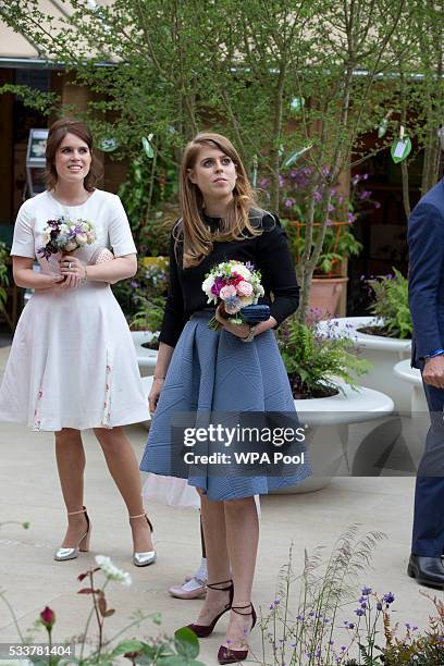 Princess Eugenie and Princess Beatrice in the RHS Greening Grey Britain Garden by Anne-Marie Powell attend the Chelsea Flower Show press day at Royal...