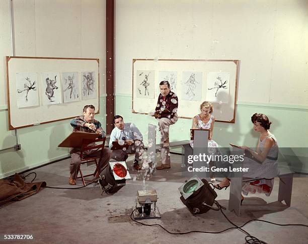 Walt Disney animators sketching together at Disneyland in circa 1955 in Anaheim, California.