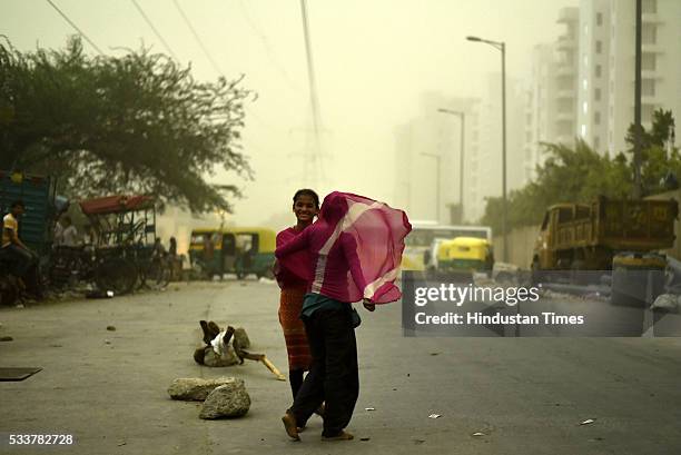 Two girls caught in a sand storm wind on May 23, 2016 in New Delhi, India. Rains after a sand storm brought respite for people in capital after a hot...