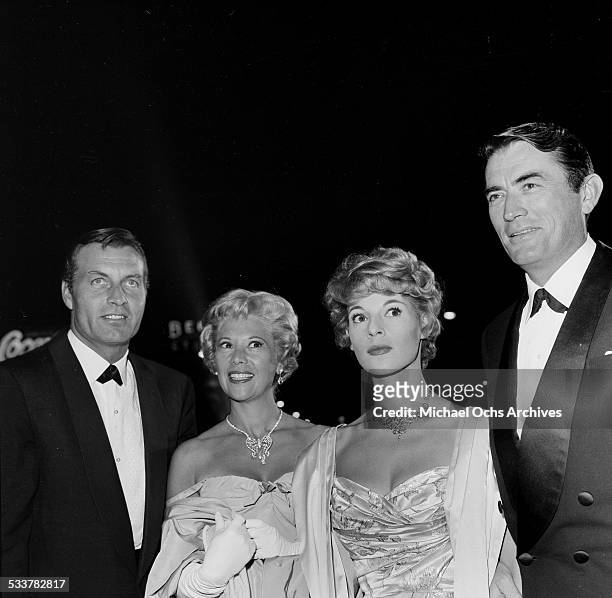 Actor Gregory Peck and his wife Veronique Passani with actor George Montgomery and singer Dinah Shore attend the premiere of "The Big Country" in Los...