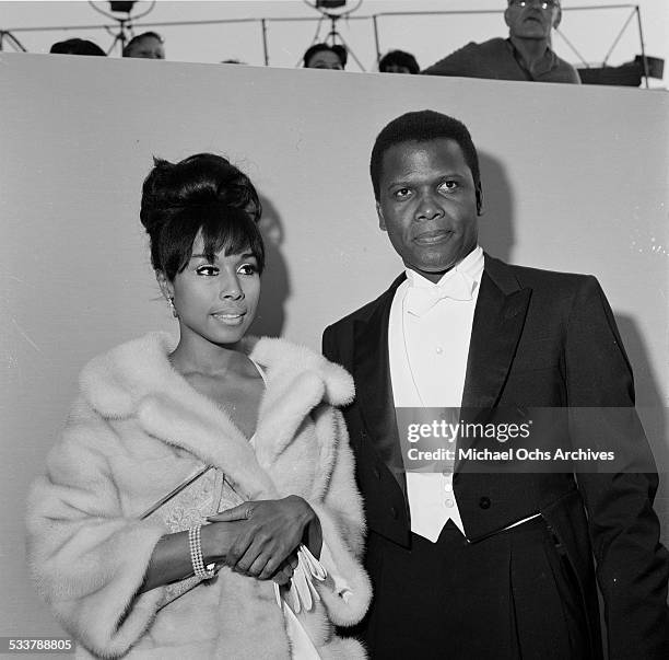 Actor Sidney Poitier with actress Diahann Carroll attend The 36th Academy Awards in Santa Monica,CA.