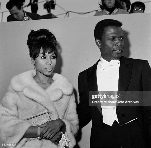 Actor Sidney Poitier with actress Diahann Carroll attend The 36th Academy Awards in Santa Monica,CA.