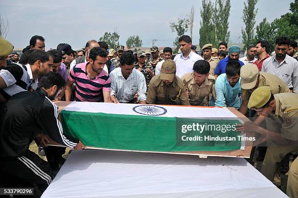 Policemen and relatives carry the coffin of one of the policemen killed in terror attack during a wreath laying ceremony at Police Control Room on...