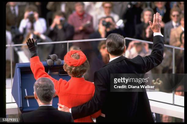 President Ronald Reagan and wife Nancy waving to crowd after swearing-in.