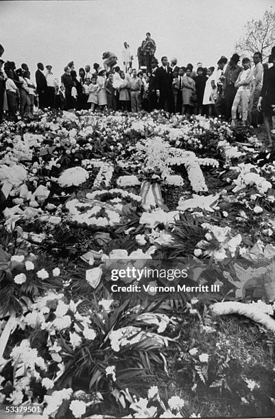 Floral offerings cover grave of assassinated civil rights leader Martin Luther King Jr. In Atlanta cemetery.