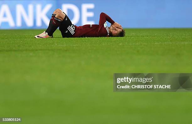 Nuremberg's defender Tim Leibold reacts after the German Bundesliga second-leg relegation football match FC Nuremberg vs Eintracht Frankfurt in...